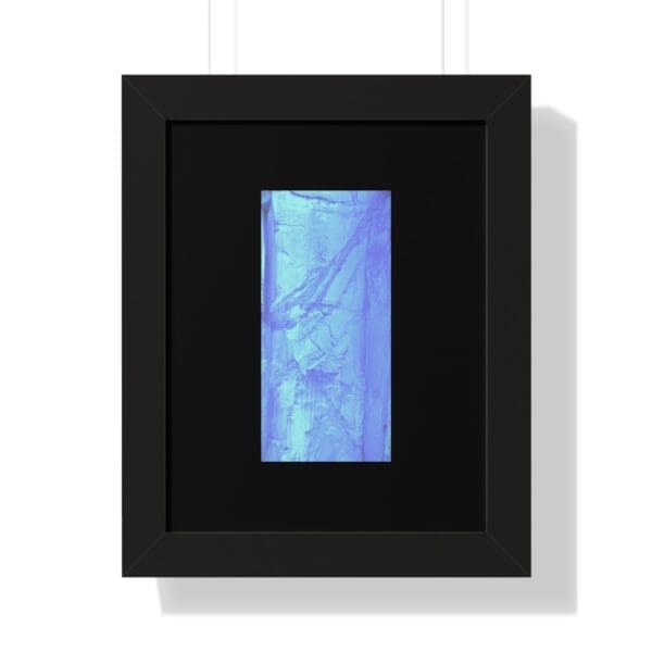 Framed abstract blue artwork on display.