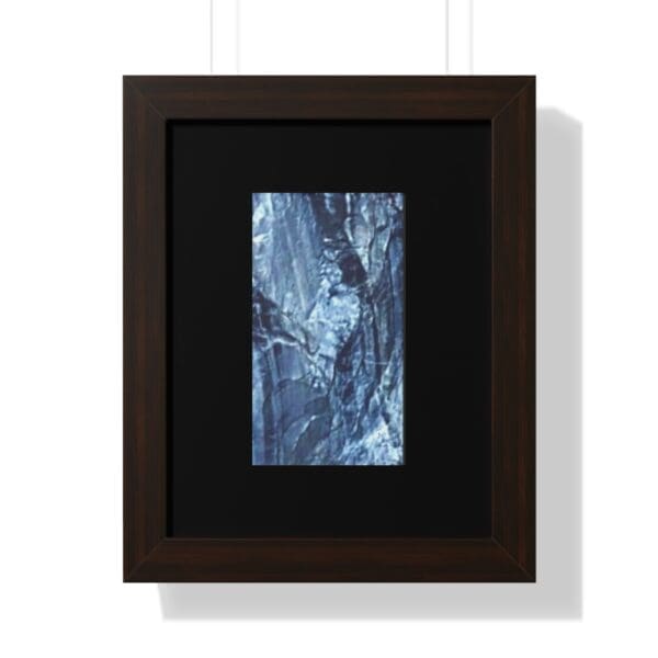 Framed abstract blue and black textured artwork.